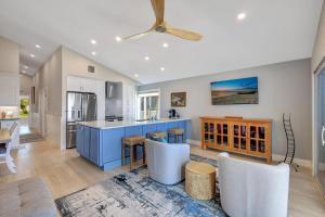 a kitchen with a blue island and a dining room at Captiva Hide A Way 2B in Captiva