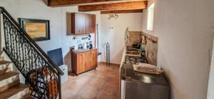 a kitchen with a stainless steel refrigerator and a staircase at Liana's home in Gallo