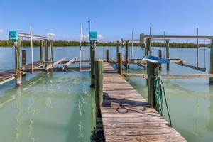 a dock on a body of water at Coconut Palm House in Captiva