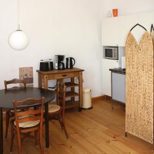a dining room with a table and a kitchen at Domblick an der Freiheit in Meißen +23 photos