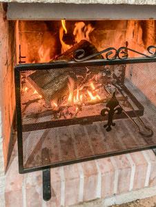 a fireplace with a fire in it with a fire at Liana's home in Gallo