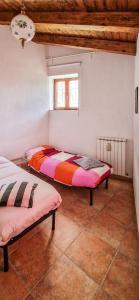 a bedroom with two beds and a window at Liana's home in Gallo