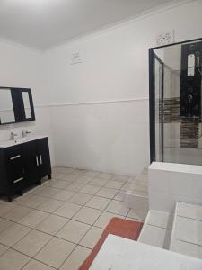a white room with a sink and a mirror at 1krom str bellville boston in Bellville