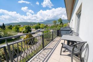 a balcony with a table and chairs and a view at Bright two bedroom duplex apartment in Divonne-les-Bains +11 photos