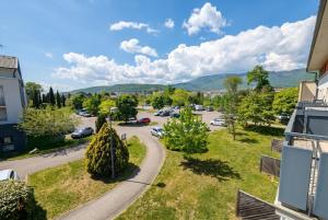 arial view of a street with trees and a parking lot at Bright two bedroom duplex apartment in Divonne-les-Bains