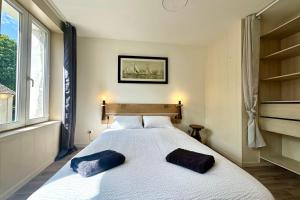 a bedroom with a large bed with two pillows on it at Retraite cosy aux portes de la Baie de Somme in Abbeville