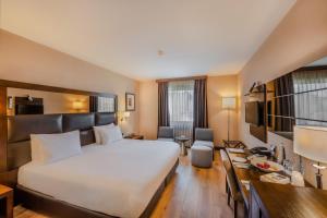 a hotel room with a large bed and a desk at Midtown Hotel in Istanbul