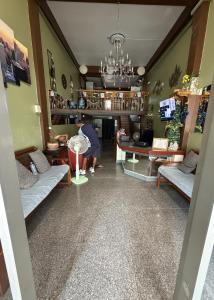 a person in a room with a table and chairs at Yuma Tashi Hostel in Bangkok +26 photos