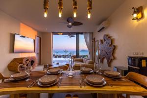 a dining room with a wooden table with wine glasses at Villa Kinnari in Ko Phangan