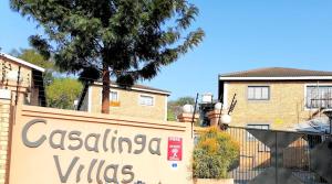 a sign for a villa in front of a building at Uptown Apartments - Casalinga Villas in Mataffin