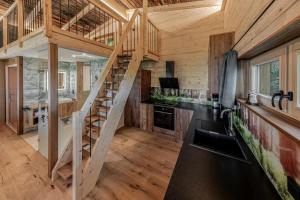 a kitchen with a staircase in a log cabin at Garnecker Freiheit in Reut
