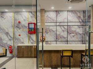 a lobby with a wall covered in marble at IPOH AVS HOTEL by VERVE in Ipoh