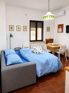 a bedroom with a blue bed and a table at Sila Magico Incanto in Camigliatello Silano