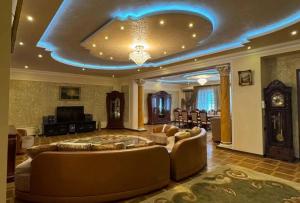 a large living room with couches and a television at Sirik guest house in Geghanist