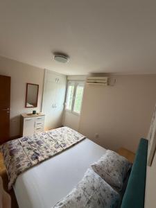 a bedroom with a large white bed in it at Pizana Budva Central in Budva