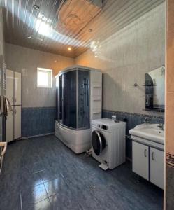 a bathroom with a sink and a washing machine in it at Sirik guest house in Geghanist