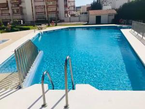 a large blue swimming pool in a building at CASA PLAYA - HOME RENt MALAGA in Torre del Mar