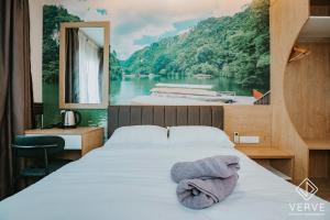 a bedroom with a bed with a view of a river at IPOH AVS HOTEL by VERVE in Ipoh