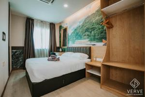 a hotel room with a bed with a teddy bear on it at IPOH AVS HOTEL by VERVE in Ipoh