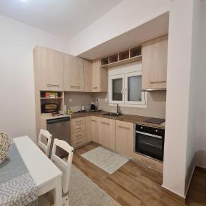 a kitchen with wooden cabinets and a table with chairs at Rizes in Pramanta +12 photos