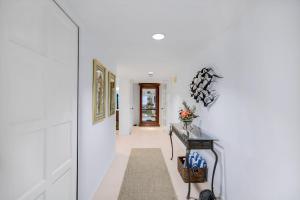 a hallway with white walls and a white hallway at Beachcomber A101 in Sanibel