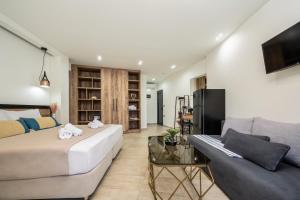a living room with a bed and a couch at Moon Boutique Hotel - Ultra Luxury Suites with Pool, Perfect for Fun and Relaxation By Villa Mana Gers in Laganas