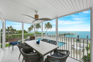 a porch with a table and chairs and the ocean at Captiva Hide A Way 1B in Captiva