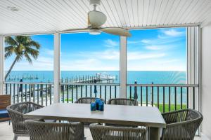 a table and chairs with a view of the ocean at Captiva Hide A Way 1B in Captiva