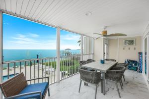 a dining room with a view of the ocean at Captiva Hide A Way 1B in Captiva