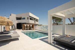 a villa with a swimming pool and a house at Moon Boutique Hotel - Ultra Luxury Suites with Pool, Perfect for Fun and Relaxation By Villa Mana Gers in Laganas