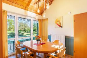 a dining room with a wooden table and chairs at Ferienhaus Gut Düneburg in Haren