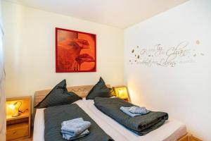 a bedroom with two beds and a sign on the wall at Ferienhaus Gut Düneburg in Haren