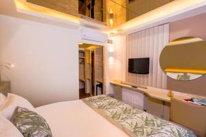 a bedroom with a bed and a desk and a television at Hotel 2000 Kavaklıdere in Ankara +25 photos