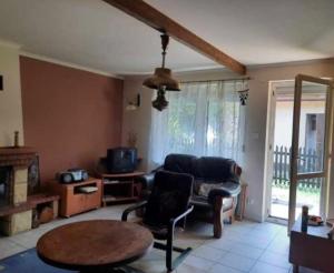 a living room with a couch and a table at Domek Letniskowy in Radawa