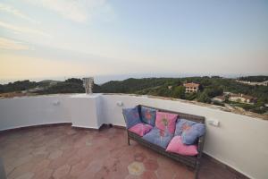 a couch sitting on a balcony with a view at Torre Biancaluna in Vico del Gargano