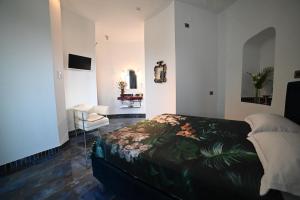a bedroom with a bed and a chair in it at Torre Biancaluna in Vico del Gargano