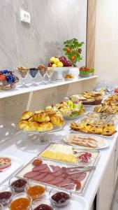 a buffet with many different types of food on a table at Al-Xorazmiy Hotel in Urganch