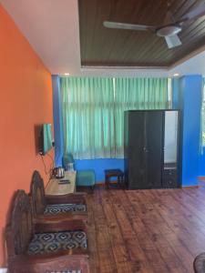 a living room with a large television and a couch at SPKA Jungle Resort in Vālpārai