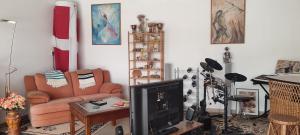 a living room with a tv and a couch and a chair at Blue Zoon Alcobaça 2p in Carrascal