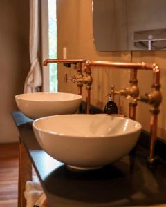 two white sinks on a counter in a bathroom at Camp Canoe in Franschhoek +50 photos