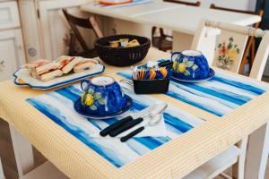 a table with blue dishes and utensils on it at CETARA - ALBERGO DIFFUSO in Cetara