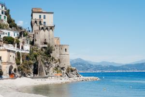 a castle on a hill next to the water at CETARA - ALBERGO DIFFUSO in Cetara