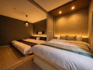 a bedroom with two beds in a room at 将軍町家 in Nagoya +15 photos