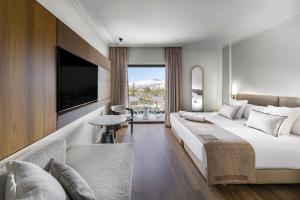 a hotel room with a large bed and a tv at Hotel Atlantic El Tope in Puerto de la Cruz +22 photos