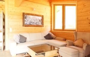a living room with a white couch and a table at Alpenchalet im Leutaschtal in Leutasch