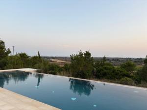 a swimming pool with a view of the countryside at Masseria Fabrizio in Otranto
