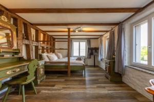 a bedroom with a bed and a desk in a room at Charming Swiss Lake View studio apartment in Wädenswil +12 photos