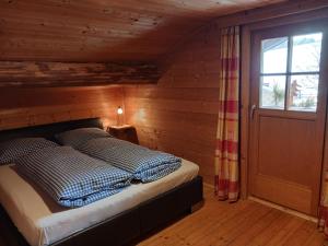 a bedroom with a bed in a wooden room at Schröckhütte in Bad Hofgastein