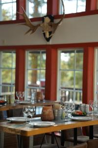 a table with plates of food and wine glasses at Bjursås Bergsgård in Bjursås