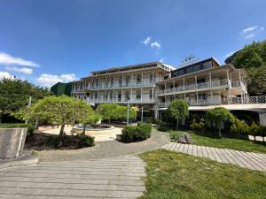 a large building with a walkway in front of it at Hotel Cash in Tbilisi City